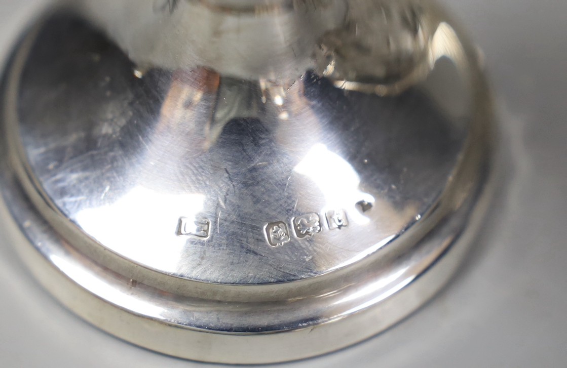 An Edwardian silver two handled posy vase, 13.7cm, a silver mounted glass scent bottle and three similar toilet jars.
